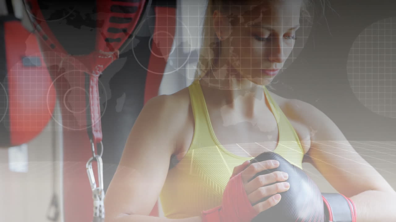 woman tightening boxing gloves in fitness gym, with animated grid and world map overlays