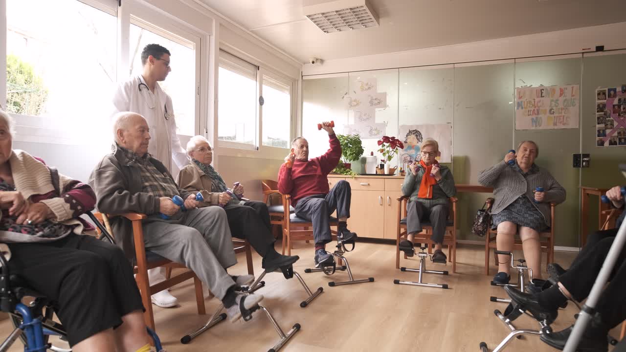 Senior men and women doing pedal exercises and lifting dumbbells at rehabilitation center
