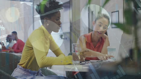 Animation-of-infographic-interface-and-diverse-female-colleague-discussing-ideas-over-laptop-at-desk