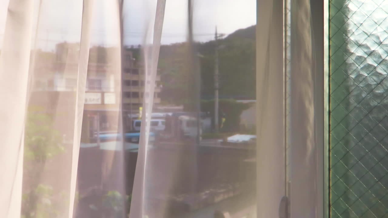 Okinawa Days. Curtain blows slowly in the wind on a summer day. Slow and calm Okinawa Japan.