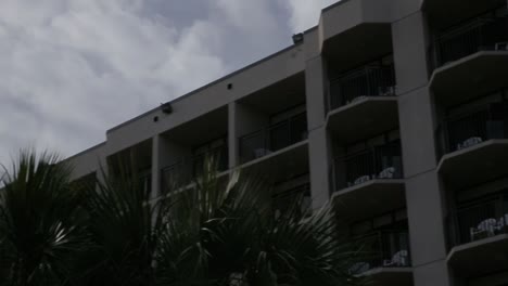 airplane-flies-over-hotel-on-beach