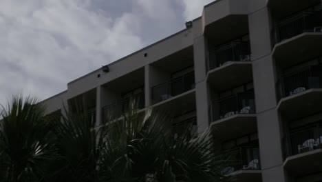 airplane flies over hotel on beach