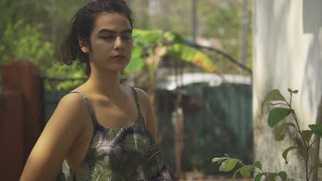 Pretty-young-Indian-woman-looks-very-mysterious-as-she-faces-the-camera-in-the-middle-of-a-garden