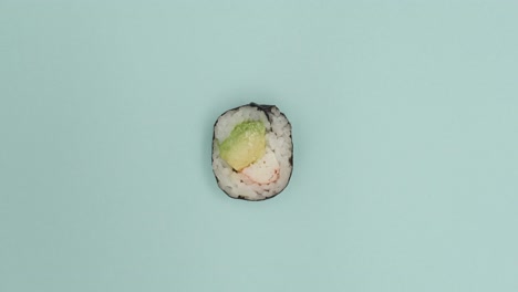 sushi roll rotating on blue background