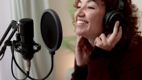 latin singer recording song for new album inside music production studio