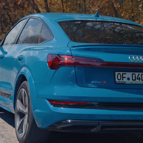 audi e-trone alone on road. close up of the rear of blue audi e-tron