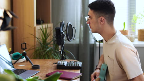 Young-man-playing-music-at-home