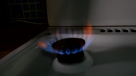 fire from old burner stove top, in domestic kitchen for cooking with flames propane gas or methane burning.