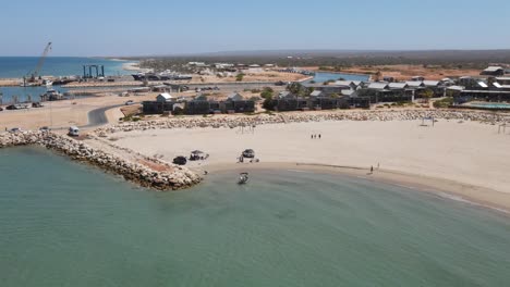 4K-Little-boat-arriving-landing-to-the-sand-beach-coast-in-green-turquoise-ocean-water