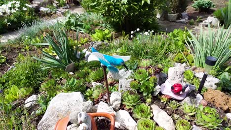 blue bird wind toy in garden v2