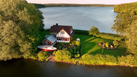 aerial view of a picturesque house by a lake with a boat on the shore