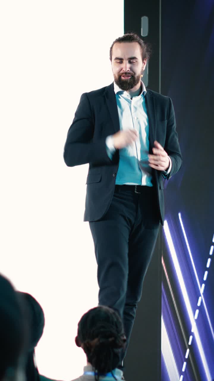 Vertical Video Male CEO presenting new mobile phone product launch on stage