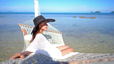 beautiful woman relax on hammock or swing around sea beach ocean for leisure travel and vacation