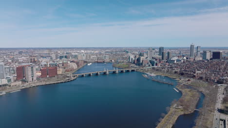 Forwards-fly-above-deep-blue-surface-of-Charles-river-at-Longfellow-Bridge.-Aerial-panoramic-view-of-metropolis.-Boston,-USA