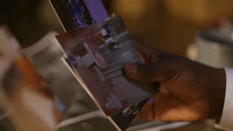person looking at old photos of a bathroom