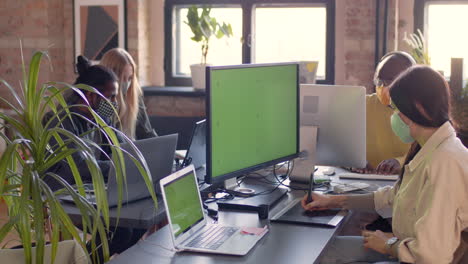 multiethnic team of graphic designers with face masks working together in an animation studio 1