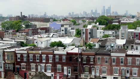 aerial establishing shot of kensington neighborhood, philadelphia skyline on horizon on summer day