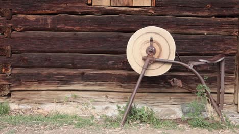 Handheld-shot-of-an-antique-pedal-powered-grinding-stone