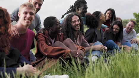 multiethnic happy group of people having fun outdoor by the lake