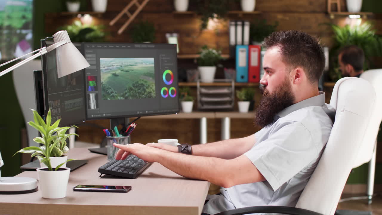 Man working on computer at desk in office