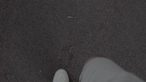 4k slow motion of a man walking on a concrete road