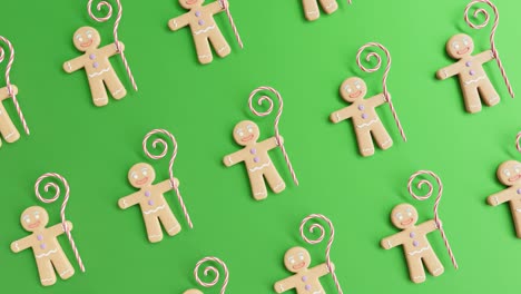 gingerbread men and candy canes on a green background