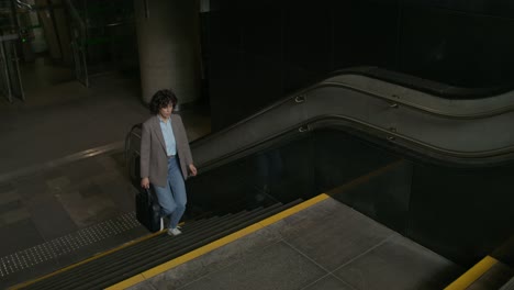 woman walking down stairs in subway station