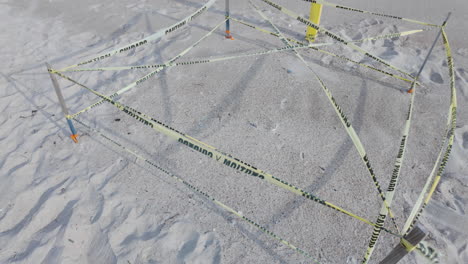 Downward-shot-of-a-sea-turtle-nest,-roped-off-to-protect-the-eggs