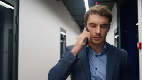 worried businessman making call leaving office closeup. stressed investor walk