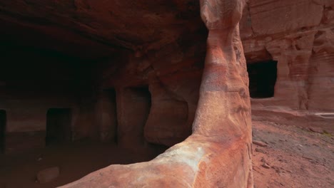 walking along tombs in petra close to the treasury, historic unesco heritage site carved into red rock sandstone in jordan. famous indiana jones movie filming location and tourist destination khaznet.