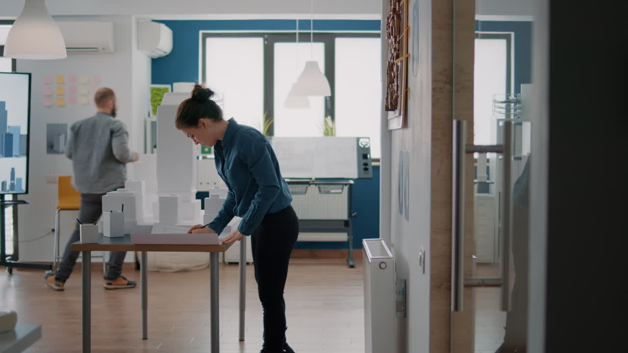 Architects working on a building model in a modern office