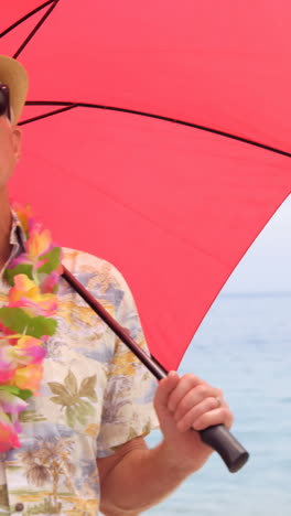 retired man on the phone under his umbrella