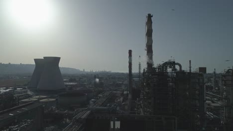 silhouette-of-a-large-scale-Oil-refinery-with-smoke-stacks-and-petroleum-storage-tanks