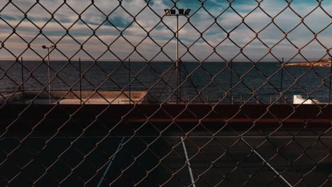 an empty basketball stadium on the coast of bugibba, malta. panning shot