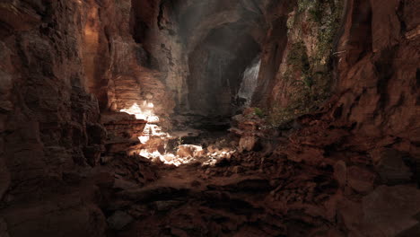 a sunlit path through a dark cave