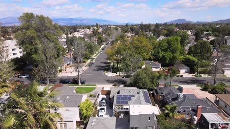 Rising-aerial-view,-neighborhood-of-Van-Nuys,-cloudy-day-over-city