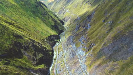 an aerial shot of a train going around the "nariz del diablo" or devil's nose in alausí, chimborazo province, ecuador