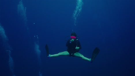 a scuba diver explores the deep blue ocean