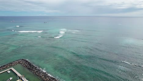 hawaiian harbor with breakwater and waves in the background- rock piles beach