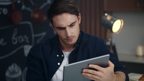 Portrait of upset business man looking tablet screen