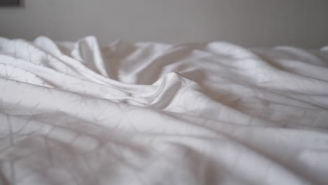 wrinkled white bed sheets