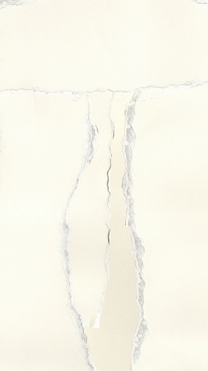 White Paper Tearing and Revealing Black Background