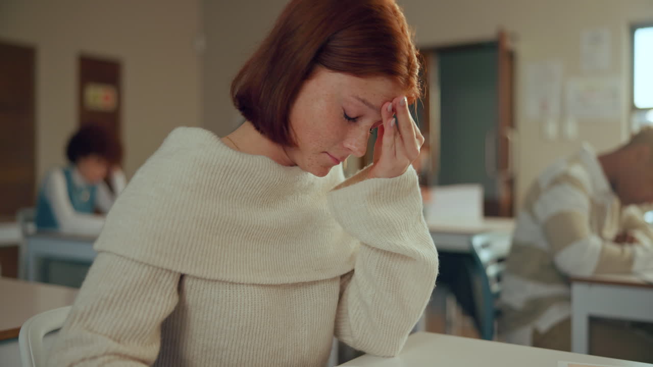 Stressed student in classroom during exam