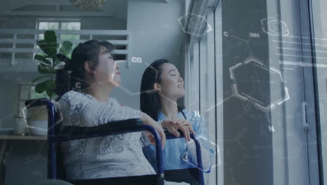 medical nurse standing with patient holding wheelchair gazing out window showing molecular graphics