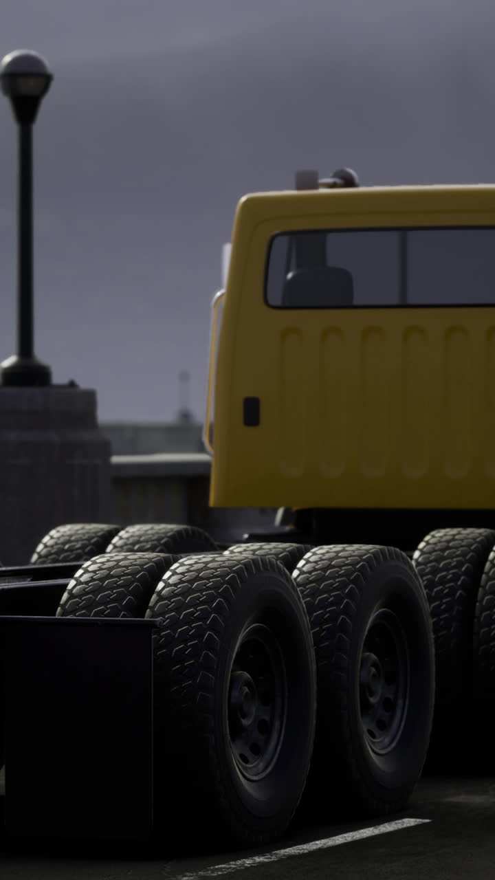 Majestic yellow truck parked near a scenic bridge on a cloudy day