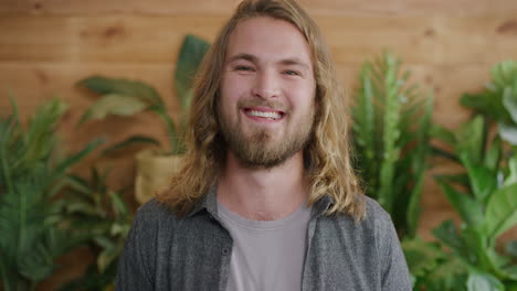 portrait of charming young man smiling happy enjoying successful lifestyle blonde caucasian male with long hair slow motion