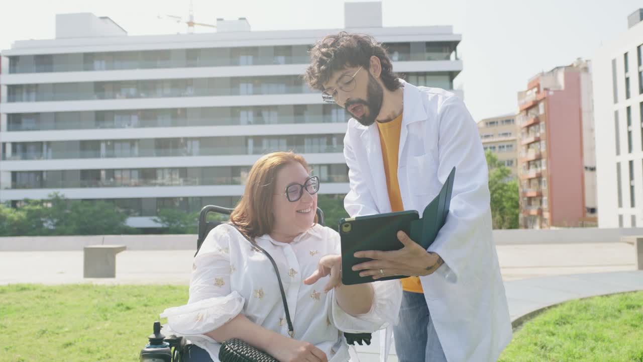 Doctor consulting with patient in wheelchair