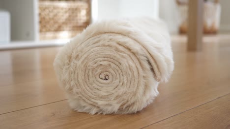 rolled beige faux fur rug