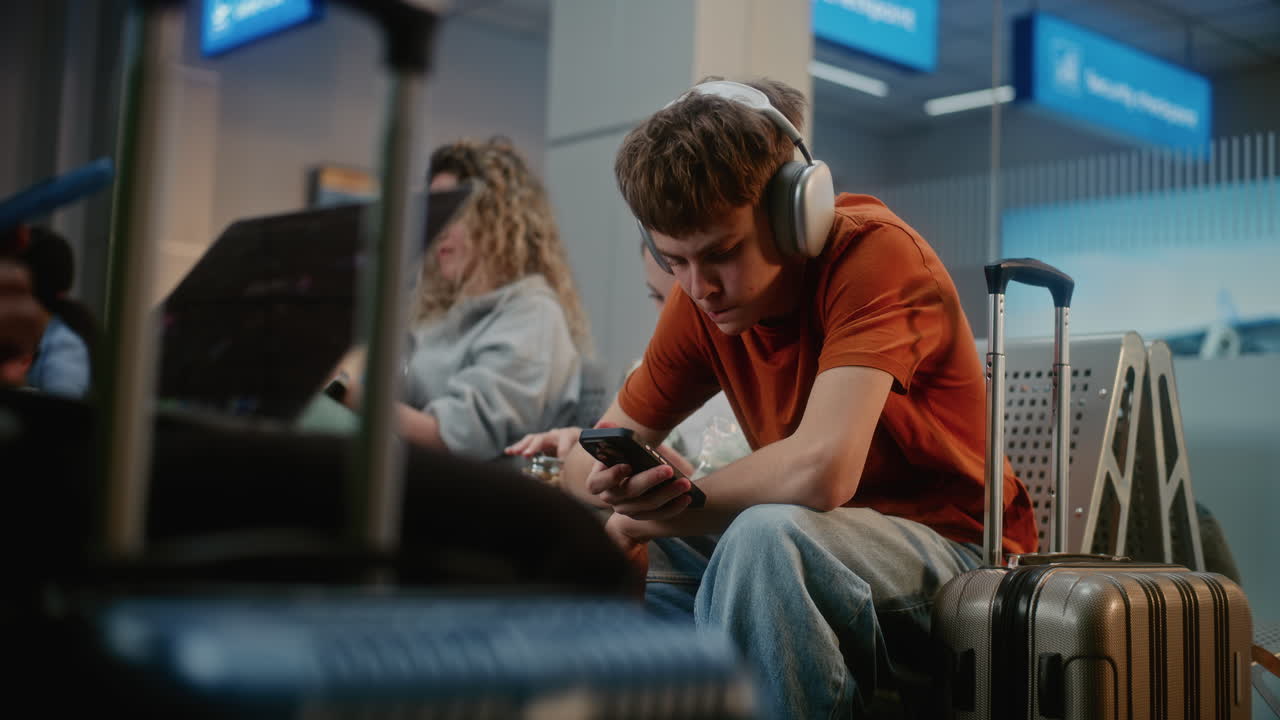 Teenagers and Family Waiting at Airport
