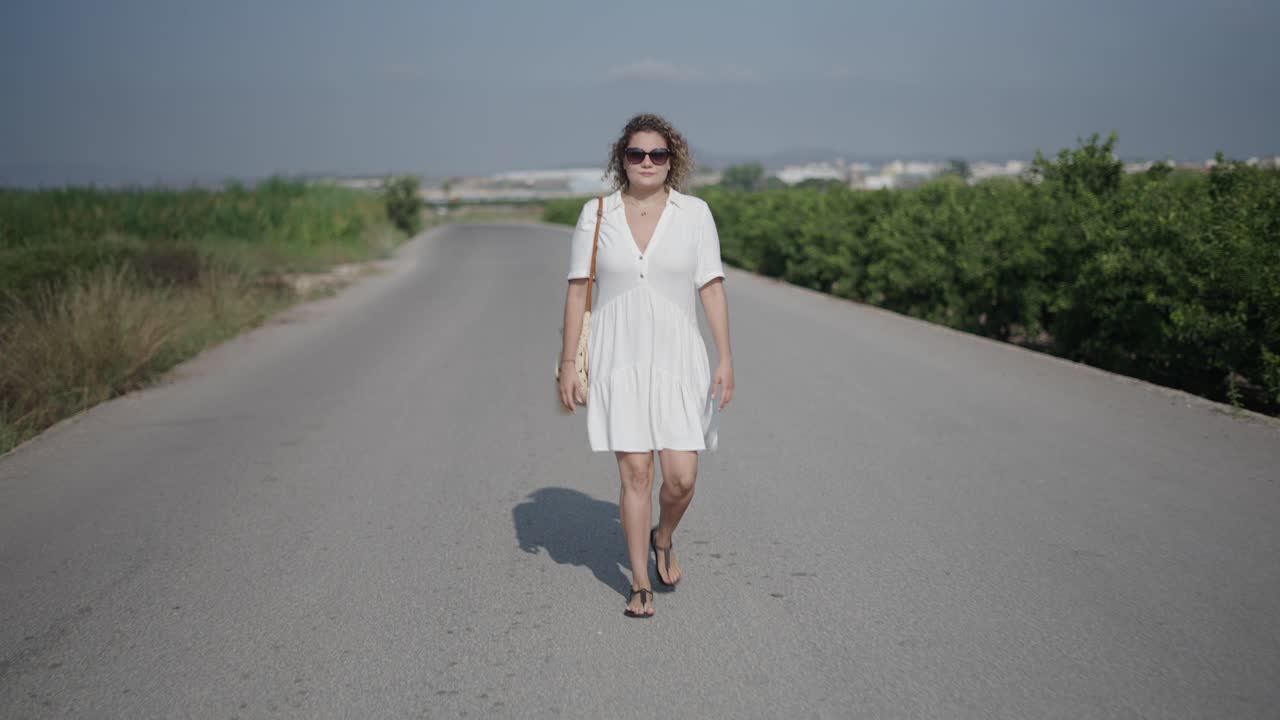 Woman Walking Down a Country Road
